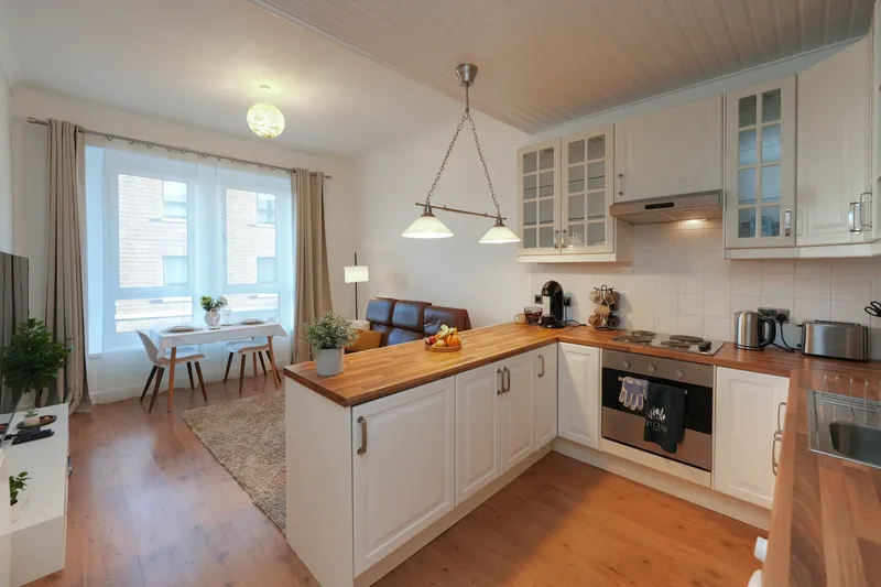 Open-plan kitchen-lounge at Saltcoats Central with modern Scandinavian design, dining table, and natural lighting